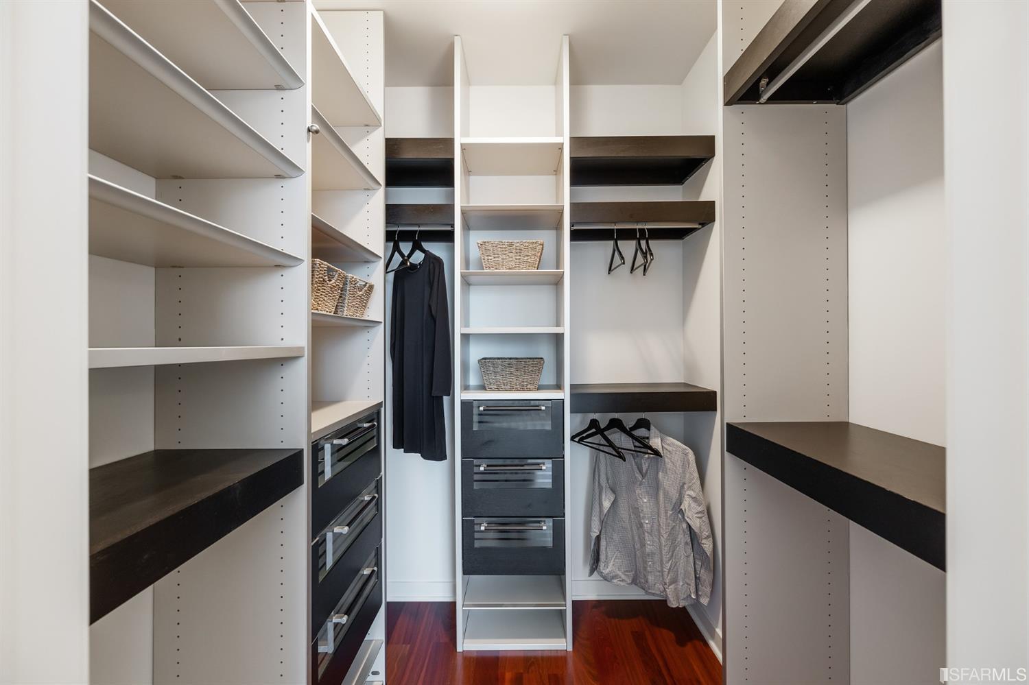 Primary bedroom walk-in closet with high-end Studio Becker closet organizers.