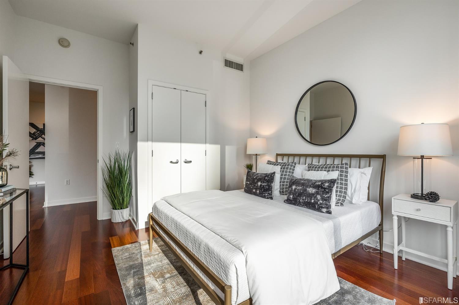 A large second bedroom with hardwood flooring.