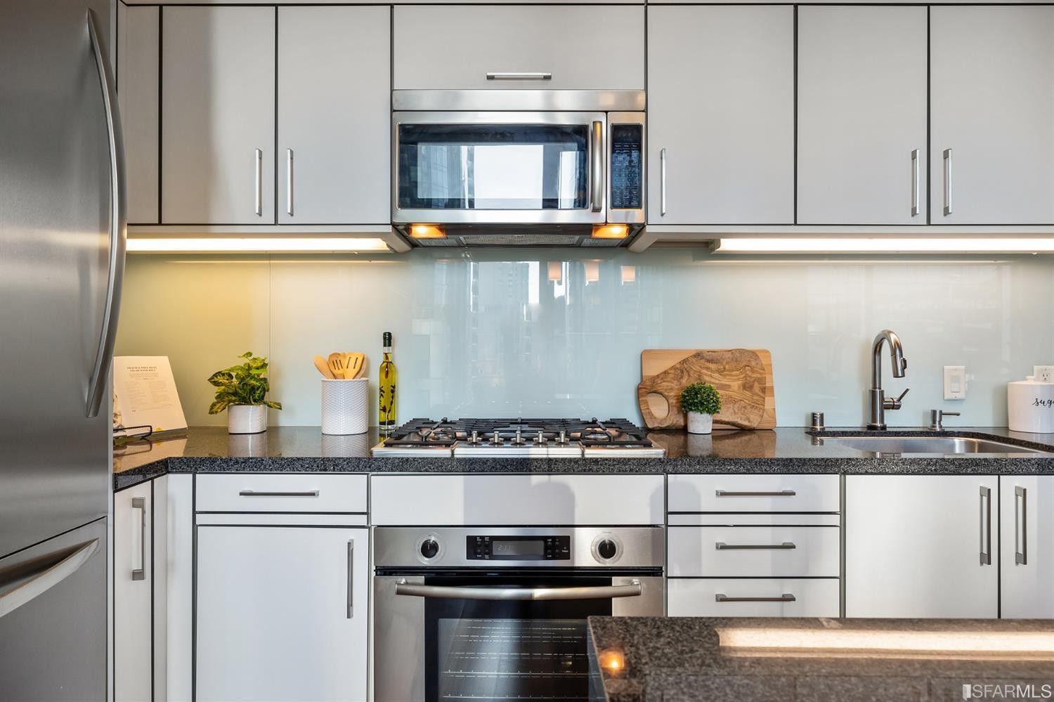 ...gas cooking, under cabinet lighting, granite counters and custom island.