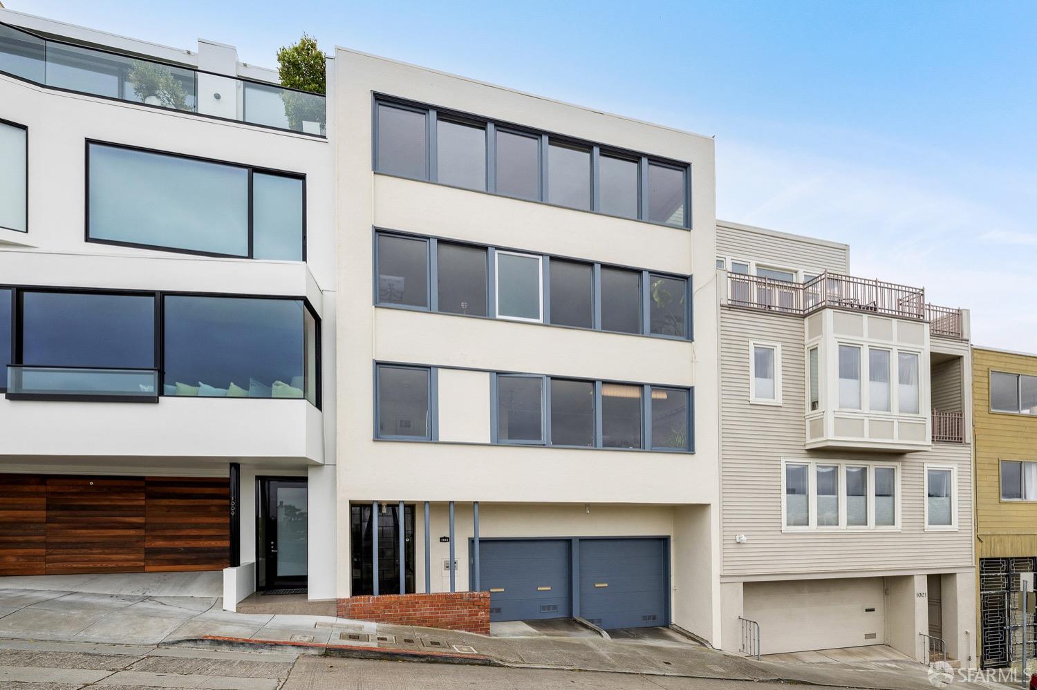 An iconic Russian Hill trophy building on Francisco St at the curve. All units feature magnificent northern views of the Golden Gate Bridge, Alcatraz and Angle Island. This 3-unit building consists of two 1-bedroom units and a huge 2-level owners unit. The first residence offers 1 bedroom, 1 bathroom, an office, storage, and an independent garage. The middle residence with 1 bedroom and 1 bathroom offers a larger layout for entertaining at over 1,000 sq.ft. of living space and includes storage with an independent garage. The top level owner's residence offers 3 bedrooms and 2 full bathrooms, one of which is en suite. The additional level is an expansive family room which opens onto the rear garden. The 2 garages for this unit are accessed through the alley above the property from Larkin St and are also independent. The rooftop features a panoramic view deck.     NOTE: Photos are digitally modified/staged.