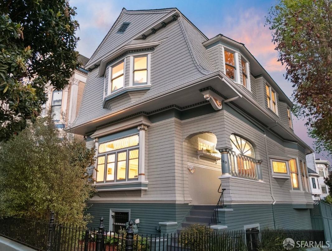 Step into a storybook Queen Anne-style home where historic charm meets modern grace. Tucked away behind a classic oak door, the grand foyer welcomes you with original leaded windows and a sweeping staircase crafted from oak and mahogany each step echoing over a century of quiet elegance.  Tuscany-style columns frame your entrance to the living space, where coffered ceilings, intricate period molding, and glowing antique light fixtures create a regal and warm atmosphere. Cozy up by the fireplaces in the living and dining rooms, or bask in natural light from the adjacent sunroom that opens onto a tranquil garden and brick patio, perfect for quiet mornings or intimate gatherings under the sky. Upstairs, three charming bedrooms await, along with a bath that feels like stepping into another era complete with a clawfoot tub and a marble-and-wood vanity that tells its own story. The lower level offers a peaceful guest suite or private office setup, with its own bath and study area. Spacious basement offers endless potential and abundant storage. Lovingly cherished by the same owner for over 40 years, the home boasts a new roof, fresh paint, updated windows, and gleaming hardwood floors. This is not just a house, it's the kind of place you fall in love with at first sight.
